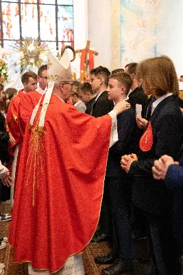 9 kwietnia w Katedrze 42 młodych osób z parafii katedralnej oraz 14 parafii Matki Bożej Częstochowskiej w Rzeszowie (Drabinianka) otrzymało sakrament bierzmowania, którego udzielił bp Jan Wątroba.
Przygotowania młodzieży trwały 2 lata, a odbywały się pod okiem ks. Krzysztofa, ks. Pawła, ks. Szczepana, s. Ewy oraz pani Agnieszki i obejmowały m.in. katechezy, spotkania formacyjne, a także przystąpienie do sakramentu pokuty. We wtorkowy wieczór kandydaci wraz ze swoimi świadkami, rodzicami, chrzestnymi czy też dziadkami zgromadzili się w Katedrze, by prosić o dary Ducha Świętego, umacniające w mężnym wyznawaniu wiary i postępowaniu według jej zasad.
Wszystkich zgromadzonych w świątyni przywitał ks. Krzysztof Gołąbek – proboszcz parafii katedralnej. Mszę Świętą koncelebrowali także ks. Tadeusz Pindara – proboszcz parafii Matki Bożej Częstochowskiej oraz kapłani posługujący w obydwu parafiach.
Następnie prośbę o udzielenie sakramentu bierzmowania zgromadzonym młodym oraz o modlitwę skierowali do Księdza Biskupa rodzice kandydatów.
W homilii bp Jan zachęcił młodych, aby w tym wyjątkowym dniu obrali Ducha Świętego za życiowego przewodnika towarzszącego im przy ważnych wyborach czy podchodzeniu do egzaminów – także tych życiowych. Wyjaśnił również znaczenie imienia Ducha Świętego – Paraklet – które tłumaczone z jęz. greckiego oznacza obrońcę, adwokata – nigdy prokuratora, nawet nie sędziego.
Będziecie moimi świadkami, gdy was umocni Duch Święty – mówi Pan Jezus. Niech nie będzie niedzieli i uroczystości bez udziału we Mszy Świętej – to jest moment dawania świadectwa. Właśnie przez zaangażowane, pełne uczestnictwo w najpiękniejszej modlitwie, jaką ma Kościół, czyli w Mszy Świętej, zdacie egzamin ze swojej dojrzałości chrześcijańskiej.
Na koniec celebrans odwołał się do obchodzonej poprzedniego dnia Uroczystości Zwiastowania Pańskiego i postawy Maryi wobec planu Bożego w Jej życiu oraz drogi, przez którą prowadził Ją Duch Święty. Podkreślił, że właśnie Maryja uczy, jak być uczennicą Ducha Świętego.
Po homilii miało miejsce odnowienie przyrzeczeń chrzcielnych. Następnie odbyła się najważniejsza część uroczystości – modlitwa Księdza Biskupa oraz namaszczenie krzyżmem każdego kandydata.
Sakrament bierzmowania jest koniecznym dopełnieniem sakramentu chrztu i wiąże się również z obraniem konkretnego patrona, którego życie i przymioty są wzorem dla młodego człowieka otrzymującego Ducha Świętego. Kandydat do bierzmowania ma więc okazję wybrać sobie świętego czy błogosławionego, którego droga do świętości najbardziej go zachwyciła. Może być to patron, którego imię nosi już od chrztu; może też wybrać sobie drugiego patrona. 
W związku z tym podczas namaszczenia krzyżmem biskup zwraca się do bierzmowanego nowo wybranym imieniem.
Po liturgii sakramentu bierzmowania miała miejsce modlitwa powszechna i liturgia eucharystyczna. Na koniec młodzi złożyli podziękowania Księdzu Biskupowi, Księżom Proboszczom oraz wszystkim, którzy poprzez swój wkład, posługę i zaangażowanie przyczynili się do przygotowania oraz przeżycia tej wyjątkowej uroczystości. Pamiątką było wspólne zdjęcie po zakończonej Mszy Świętej.
Posługę muzyczną w czasie uroczystości pełniła Katedralna Schola Liturgiczna pod dyrekcją ks. Juliana Wybrańca.

fot. Leszek Drzał
