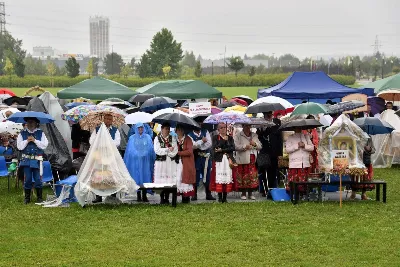 W niedzielę 29 sierpnia 2021 r. w Parku Papieskim w Rzeszowie odbyły się Dożynki Diecezjalne. Mimo deszczowej pogody do Parku Papieskiego przyjechało 57 delegacji z parafii diecezji rzeszowskiej z 65 wieńcami. Tegoroczną obsługę dożynek, w tym przygotowanie liturgii, zapewnili wierni i duszpasterze z dekanatu Rzeszów Wschód. Przed Mszą św. członkowie Stowarzyszenia Przyjaciół Ziemi Słocińskiej zaprezentowali program słowno-muzyczny. Podczas Mszy św. wystąpił chór z parafii św. Rocha w Rzeszowie pod dyrekcją Krzysztofa Husa oraz Gminna Orkiestra Dęta z Krasnego. Przed rozpoczęciem Mszy św. ks. Jerzy Uchman, diecezjalny duszpasterz rolników, przywitał przybyłych do Rzeszowa rolników, ogrodników, sadowników i pszczelarzy, wśród nich starostów dożynek: Marka Leśniewskiego i Teresę Kilar z parafii św. Rocha w Rzeszowie. Mszy św. przewodniczył bp Jan Wątroba. W koncelebrze uczestniczył bp Kazimierz Górny, ks. Wiesław Szurek oraz blisko dwudziestu księży. W długiej procesji z darami do ołtarza podeszły delegacje wszystkich obecnych parafii przynosząc chleby, wino, miód i owoce. Na zakończenie liturgii Biskup Rzeszowski pobłogosławił przyniesione płody ziemi. Po błogosławieństwie poszczególne delegacje, przedstawiane przez ks. Rafała Flaka, dyrektora Wydziału Duszpasterskiego Kurii Diecezjalnej w Rzeszowie, zaprezentowały swoje wieńce.  Fot. ks. Tomasz Nowak